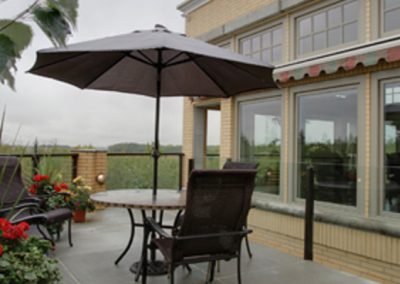 Residential outdoor patio with table and umbrella