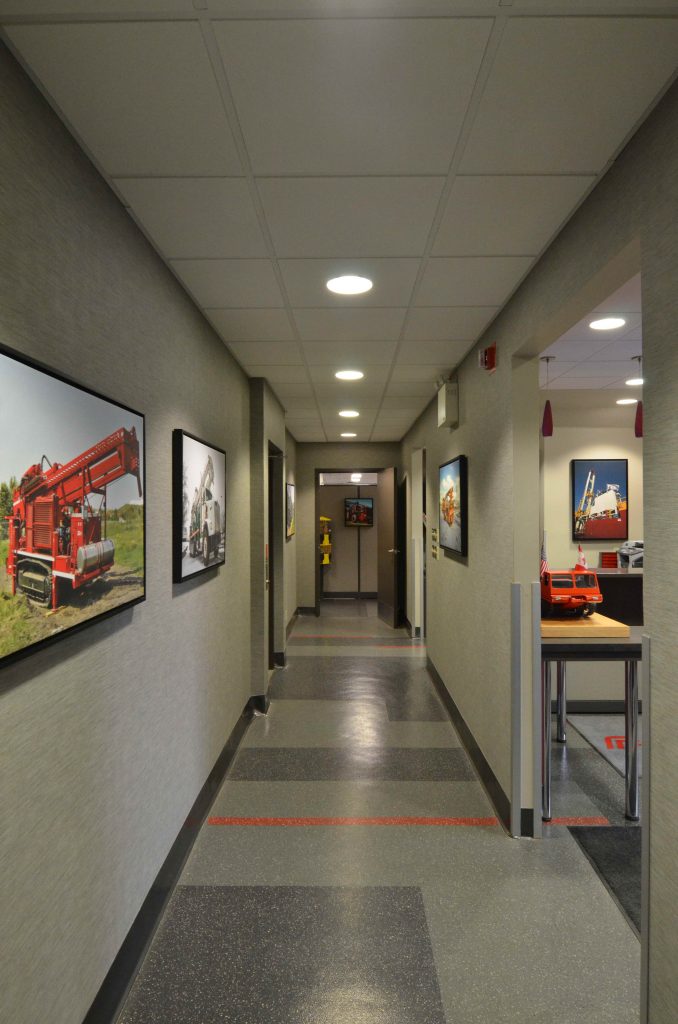 Commercial office hallway with grey and red accents
