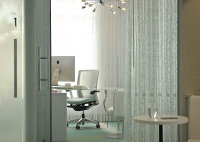 Private office with sheer drapery and sliding glass door