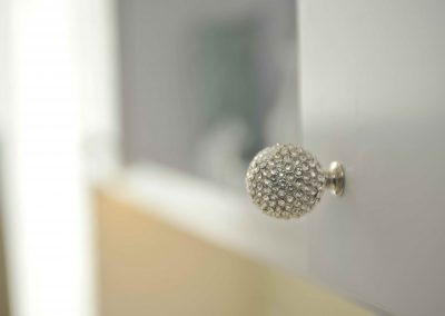 Swarovski crystal knob on white cabinet