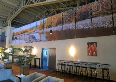 Large mural of river and trees as focal point of room