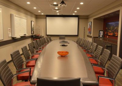 Large boardroom table positioned towards presentation display