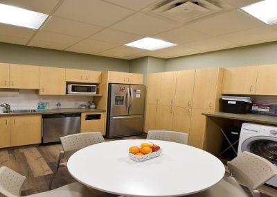 Commercial kitchen staffroom with seating area and washing machines