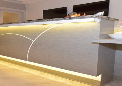 Custom front desk design with light accents