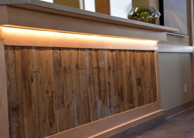 Reception desk with natural wooden elements and under counter lighting