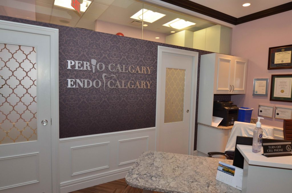 Purple damask wallpaper behind reception desk at perio clinic