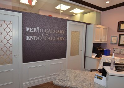 Purple damask wallpaper behind reception desk at perio clinic
