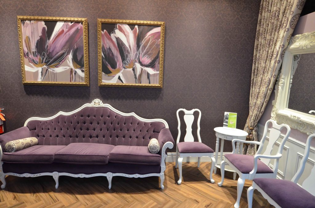 Luxurious violet and white themed waiting room with damask wallpaper