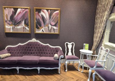 Luxurious violet and white themed waiting room with damask wallpaper