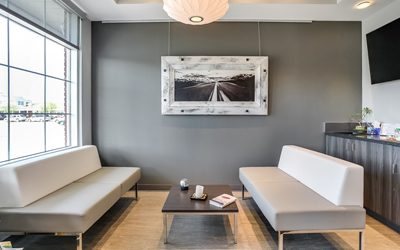 Two white and grey modern couches facing one another in waiting room