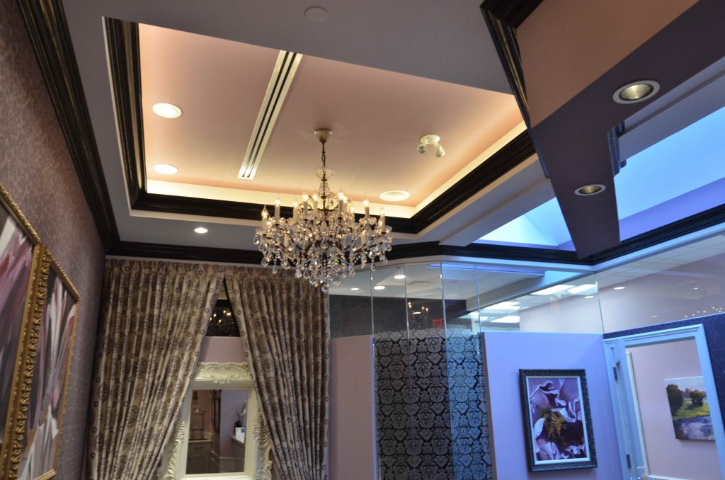 Multi level ceiling design with luxurious chandelier in perio waiting room