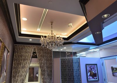 Multi level ceiling design with luxurious chandelier in perio waiting room