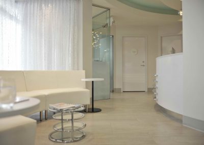 Modern dental clinic waiting room with sheer drapery letting in natural light
