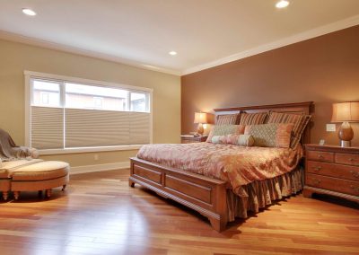 Master bedroom with kingside bed and wooden floors