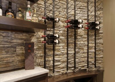 Home bar with rock wall accent and wine rack