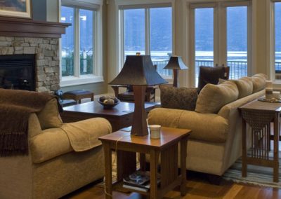 Living room area with lake view leading out to wrap around balcony