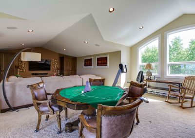 Large living room with seating area and poker table
