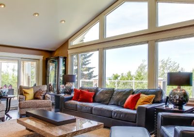 Living room with large triangular arched window letting in natural light