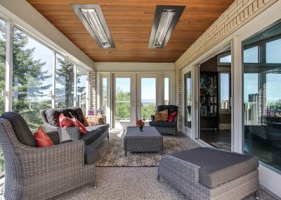 Sunroom with seating area under built in ceiling heaters