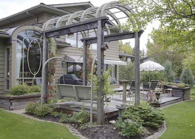 Arched backyard pergola on deck