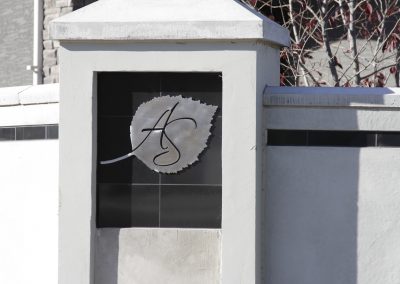 Aspen Ridge Estates Stucco Fence with black accents and silver leaf