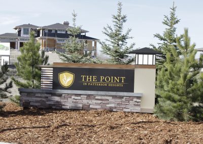 The Point in Patterson Heights community sign surrounded by small pine trees