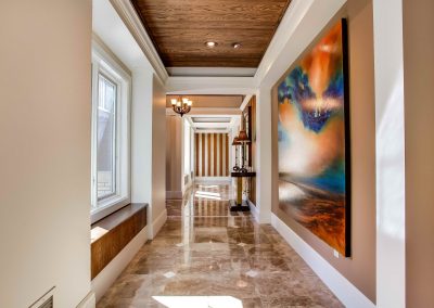 Marble floors leading through hallway at front entrance of home