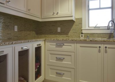Renovated laundry room with built in sliding laundry bins