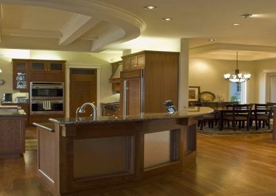 Expansive kitchen with long arching island and wooden features