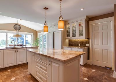 Custom kitchen renovation with quartz island and white cabinets