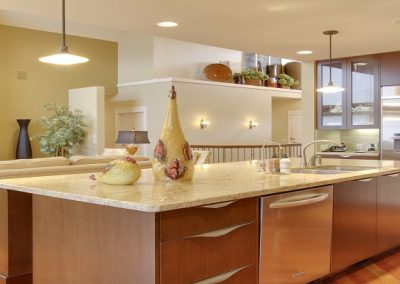 kitchen renovation with large white granite island and custom sliding wooden drawers