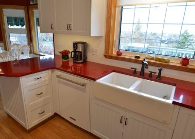Farmhouse kitchen sink and red countertops