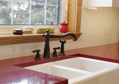 Red kitchen coutner tops in country styled kitchen