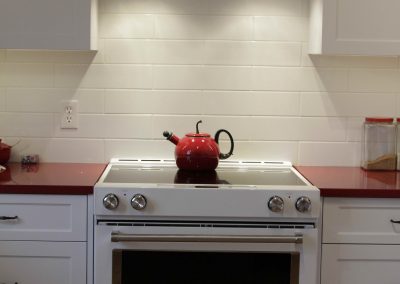 White oven with matching custom white kitchen cabinets