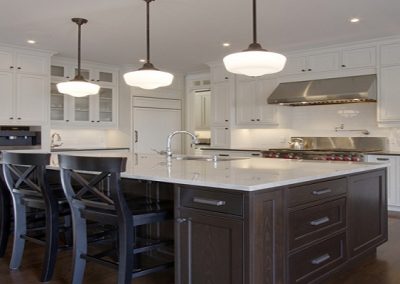 Open concept kitchen with large island with white countertops