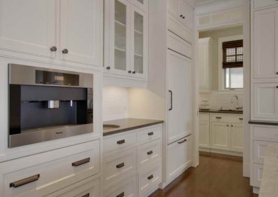 Custom white kitchen cabinet design with matching white fridge