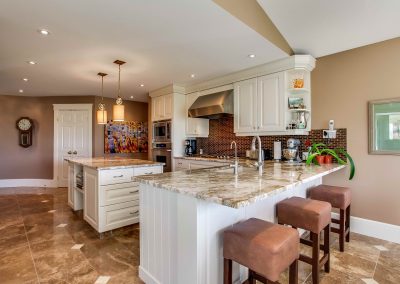 Quartz countertops with white wooden elements throughout kitchen