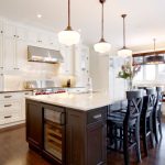 White themed kitchen renovation with contrasting dark wooden island